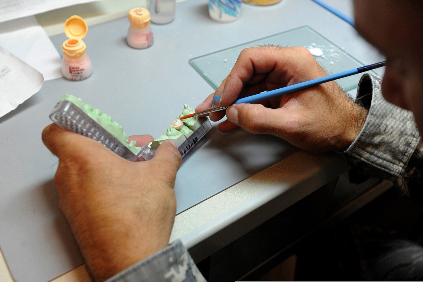 Master technician hand-building a ceramic crown