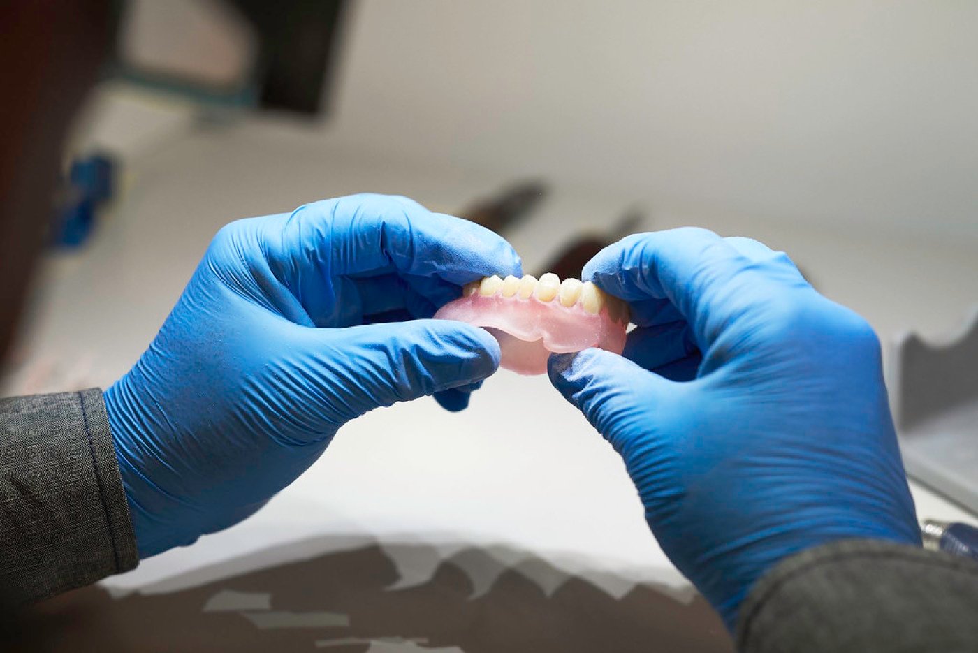Dental technician finishing a precision prosthesis